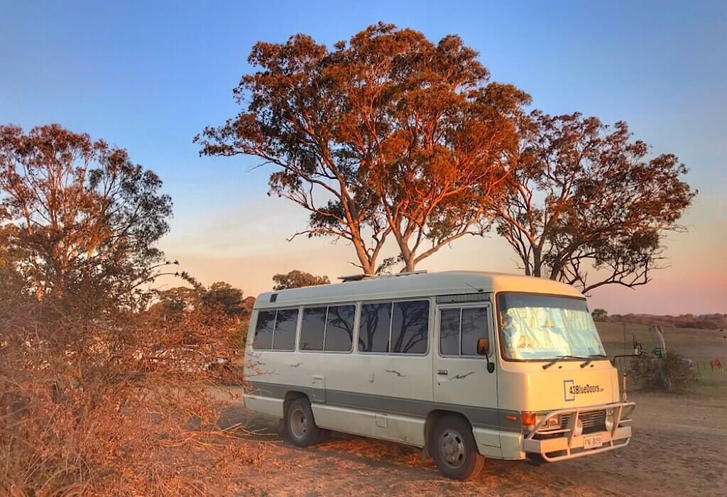 Our Toyota Coaster Lil' Beaut camped in the town of Wollomombi as the sun sets