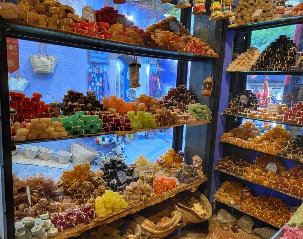 Colorful soaps for sale in Chefchaouen. The blue street can be seen behind the shelve of soap.