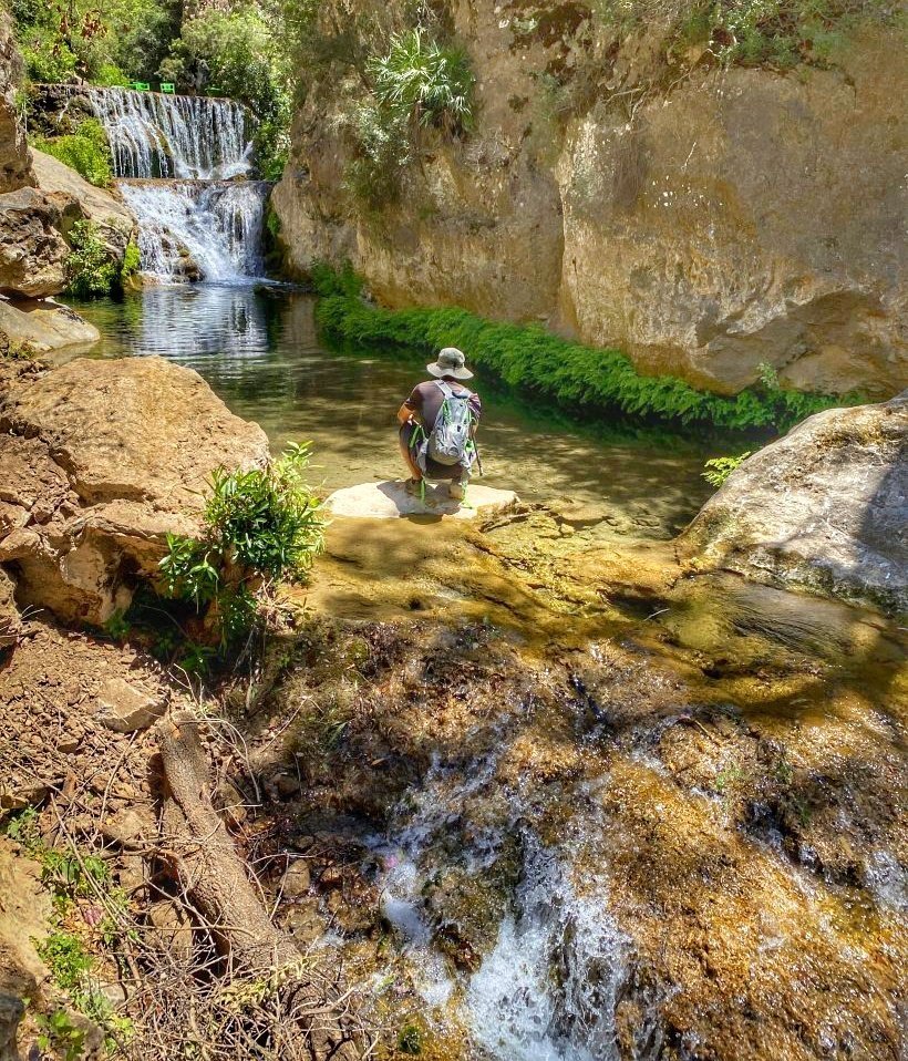 Trin on a rock in the river just below the waterfall in Talassemtane National Park