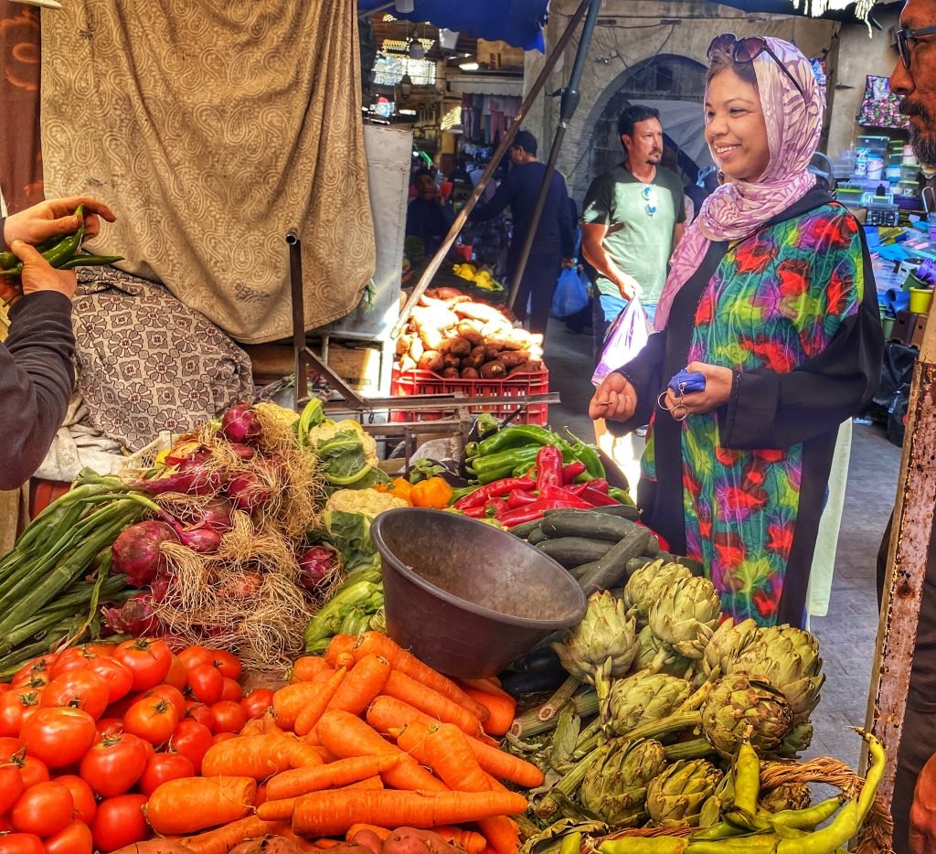 Woman buying vegetables at the market in Fex