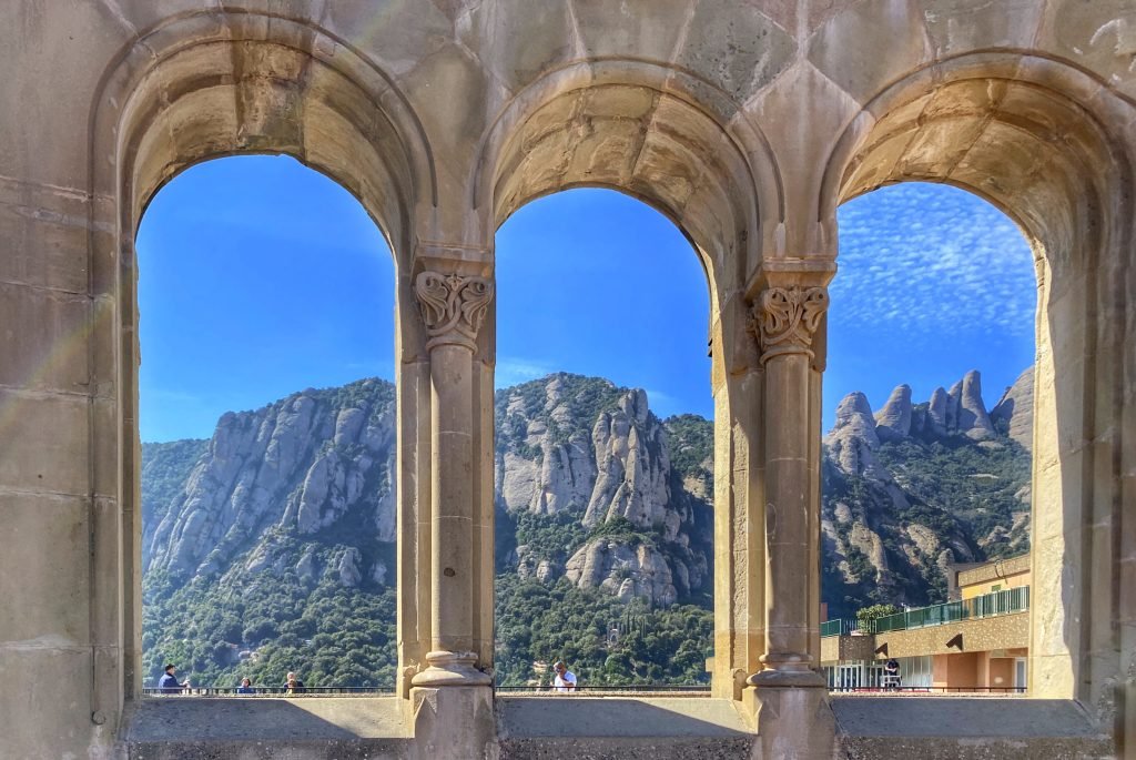 Looking through a window in the courtyard of Montserrat monastery to the serrated peaks of the mountain to which the monastery clings.