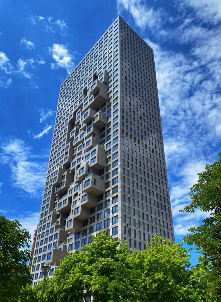 Finished high rise in Tirana, Albania. The high rise is rectangular, but windows on the side extend outward for a 3D building block appearance. 