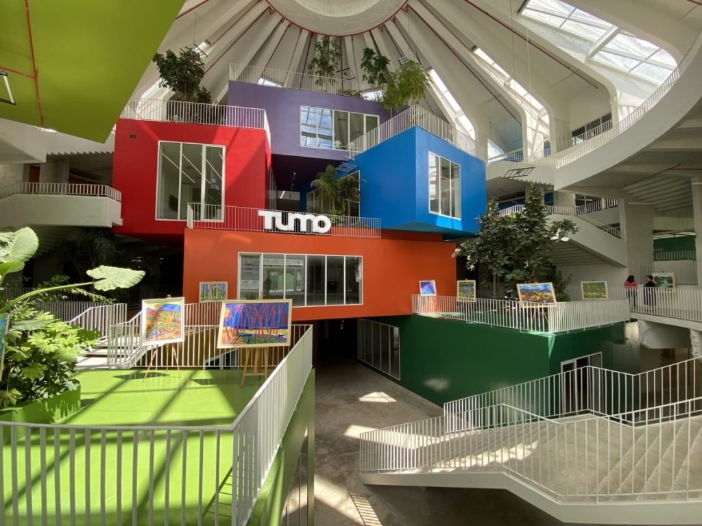 Inside the Pyramid of Tirana. Open spaces and stairs allow for multiple activities. Closed colorful boxes allow for meetings or office spaces.