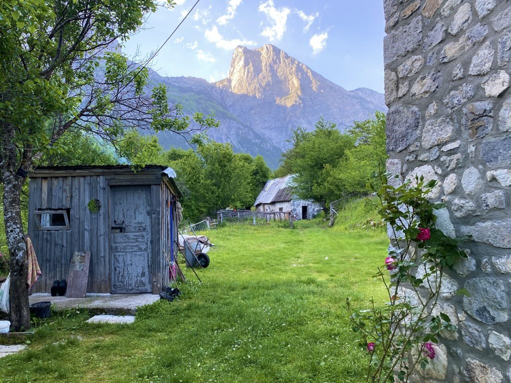 The yard of our lodge in Theth. The cook shed is on the left and dramatic mountains rise in the back.