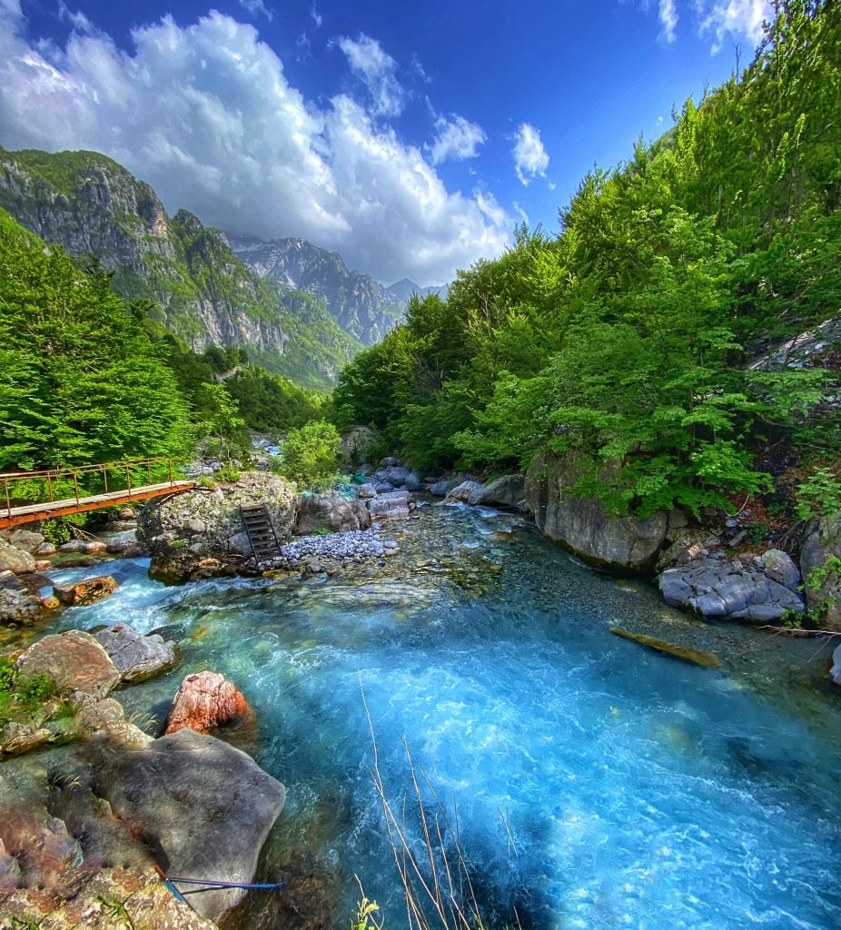 Blue water of the river from Theth running through the deep valley towards Blue Eye