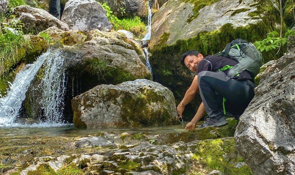 Trin cooling down with the cold clear water of the stream