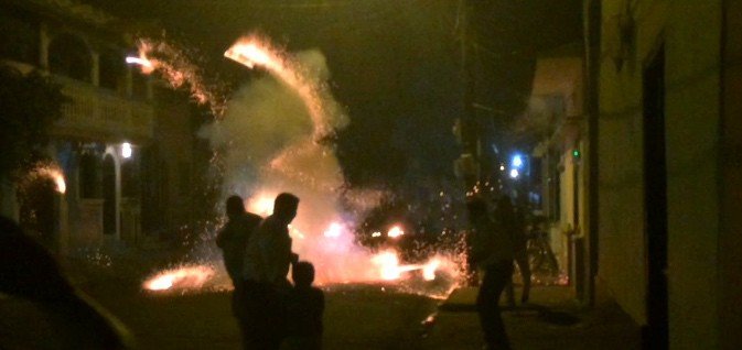 Running from the bull as rockets explode. A New Years Eve Leon tradition.