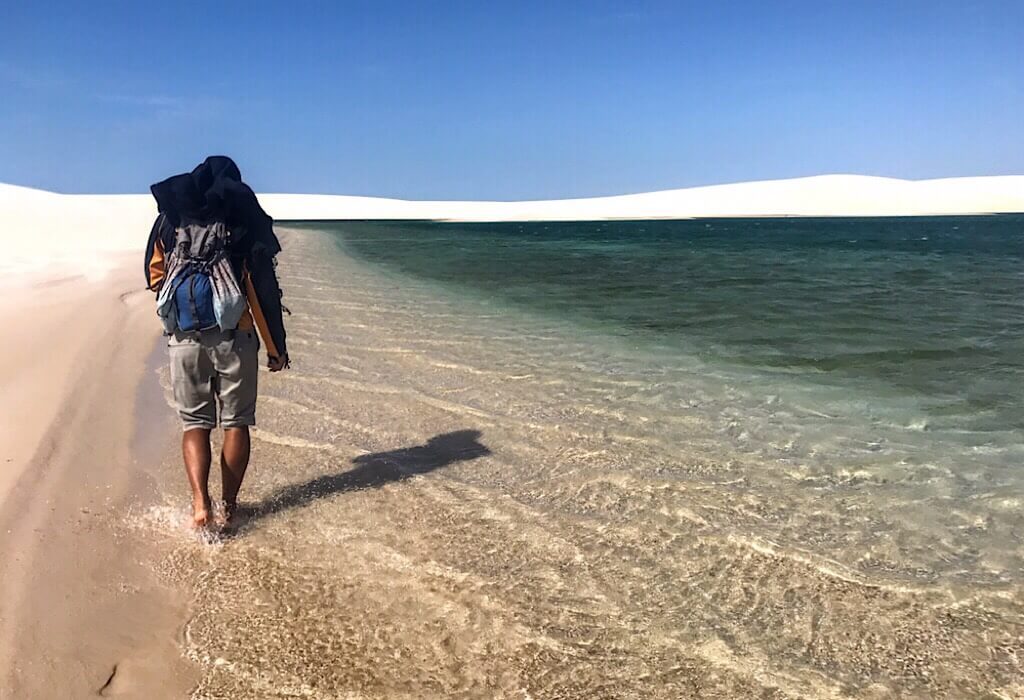 Trin walking along a sand pool in Lencois Maranhenses
