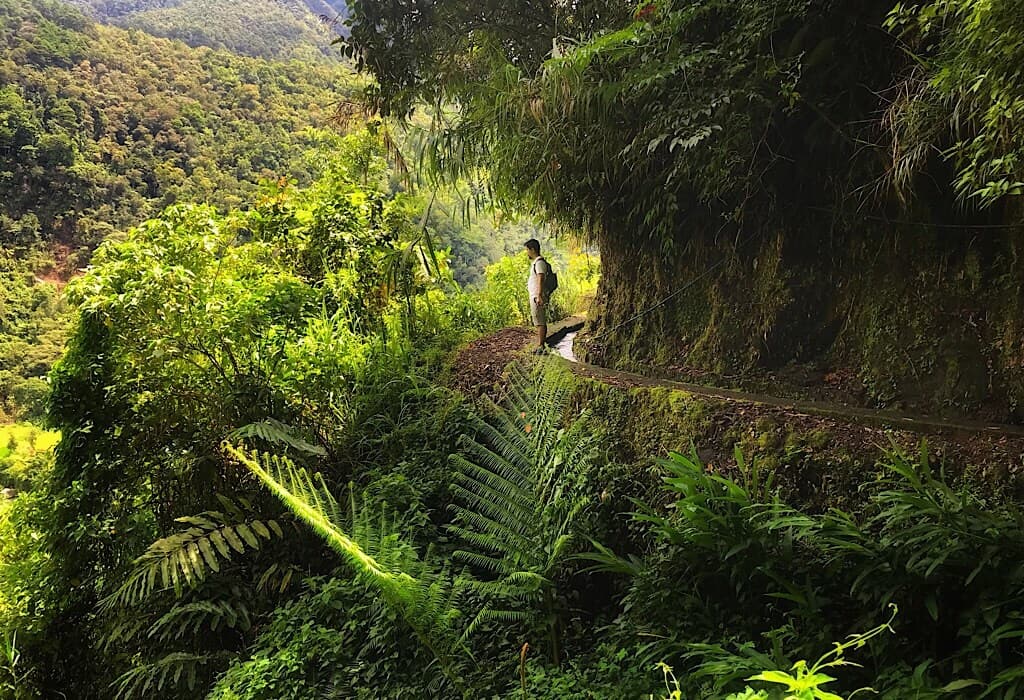 Trin standing on the edge of an irrigation canal in Banaue Philippines