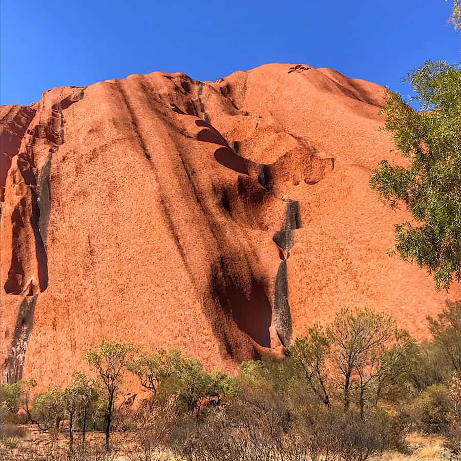 A dry riverbed on the side of Uluru