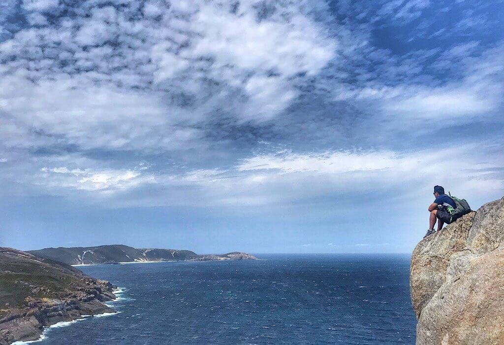 Trin sitting on the edge of Stony Hill in Torndirrup National Park