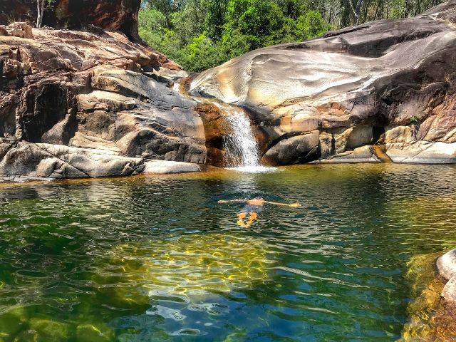 Trin floating in the swim hole below the Crystal Creek natural waterslide.
