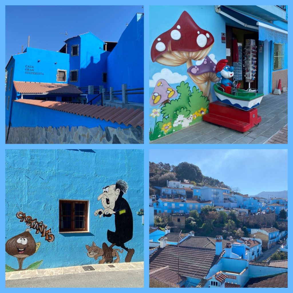 The blue building of Juzcar, Spain with paintings of mushrooms and Gargamel.
