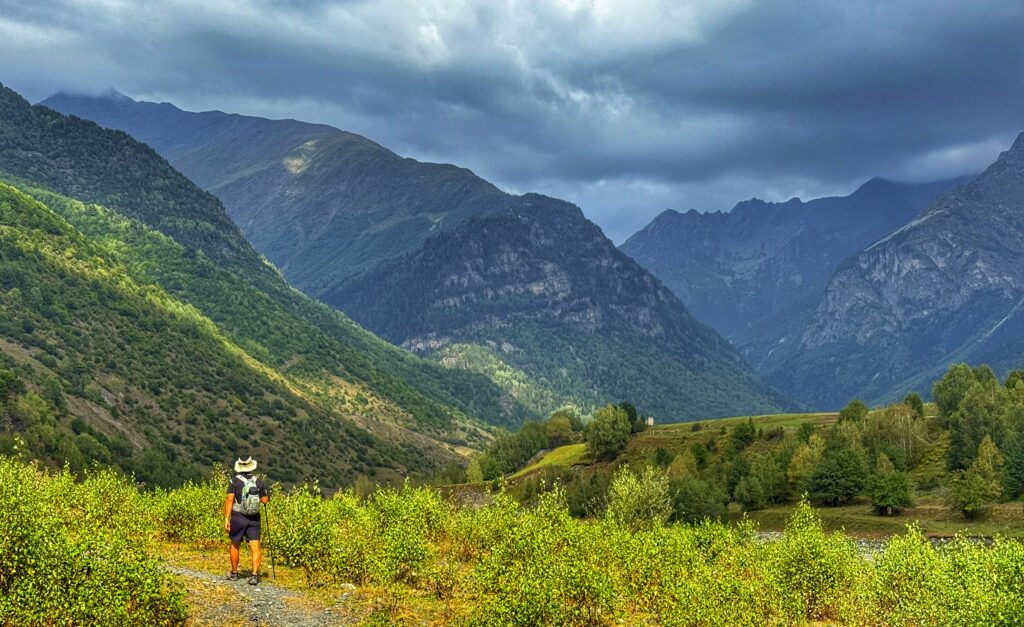 Almost to Zhabeshi, Trin is following the river surrounded by tall steep mountains.