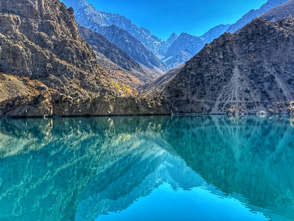 Mountains reflected on blue waters with layered colors