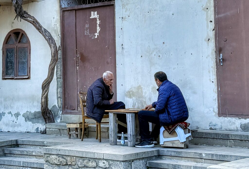 Two men playing a game outside enjoying each other's company