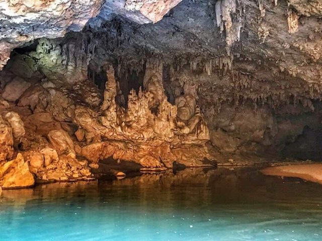 The center of Tunnel Cave where the roof has caved in allowing light to shine on the walls and water.