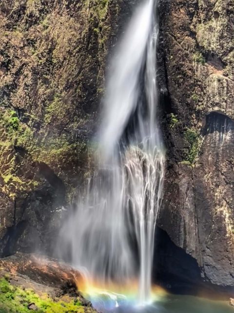 Rainbow at the base of the tall Wallaman waterfall